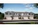 Charming townhome with light-blue siding, stone accents, a well-maintained lawn and attached garages at 350 Thompson Village Ave, Apopka, FL 32703