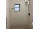 Bathroom with a new white tiled shower, gray flooring and window with natural light at 3600 Ne 22Nd Ct, Ocala, FL 34479