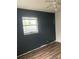 Spacious bedroom featuring wood-look flooring, a window and modern ceiling fan at 3600 Ne 22Nd Ct, Ocala, FL 34479