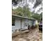 A quaint house with a paver driveway, front door, and a well-maintained exterior at 3600 Ne 22Nd Ct, Ocala, FL 34479