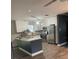 Open-concept kitchen with an island, modern appliances, and ample counter space, perfect for cooking at 3600 Ne 22Nd Ct, Ocala, FL 34479