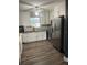 Bright kitchen featuring white cabinetry, stainless steel appliances, and hardwood floors at 3600 Ne 22Nd Ct, Ocala, FL 34479