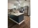 Modern kitchen with stainless steel appliances, a central island, and updated countertops at 3600 Ne 22Nd Ct, Ocala, FL 34479