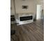 The inviting living room features a modern fireplace with stone accents and wood-look flooring at 3600 Ne 22Nd Ct, Ocala, FL 34479