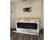 The inviting living room features a modern fireplace with stone accents and wood-look flooring at 3600 Ne 22Nd Ct, Ocala, FL 34479