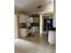 Functional kitchen with white cabinets, essential appliances, and access to a dining area at 42 Banyan Pass, Ocala, FL 34472