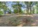 Rear of property with storage sheds and mature tree coverage at 433 Tangerine Ave, Lake Helen, FL 32744