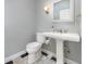 Powder room features a classic pedestal sink and black and white tile at 433 Tangerine Ave, Lake Helen, FL 32744