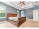 Spacious bedroom featuring a tray ceiling, ceiling fan, and natural light at 433 Tangerine Ave, Lake Helen, FL 32744