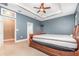 Bedroom featuring neutral carpet, a tray ceiling, and adjoining bathroom at 433 Tangerine Ave, Lake Helen, FL 32744