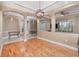 Open dining room with hardwood floors, arched entries, and modern light fixture at 433 Tangerine Ave, Lake Helen, FL 32744