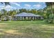 Inviting single-story home featuring a well-manicured lawn, stone accents, and a durable metal roof at 433 Tangerine Ave, Lake Helen, FL 32744
