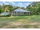 Attractive single-story home with stone accents, metal roof, and green lawn at 433 Tangerine Ave, Lake Helen, FL 32744