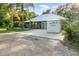 Exterior view of home featuring a spacious driveway with a portable storage unit at 433 Tangerine Ave, Lake Helen, FL 32744