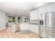 Bright kitchen with stainless steel appliances, granite countertops, and large windows overlooking the backyard at 433 Tangerine Ave, Lake Helen, FL 32744