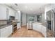 Modern kitchen with stainless steel appliances, white cabinets, and large tile flooring at 433 Tangerine Ave, Lake Helen, FL 32744