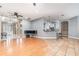 Open living space connects the living room to kitchen; features hardwood floors and stylish lighting at 433 Tangerine Ave, Lake Helen, FL 32744