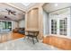 Open-concept living room featuring hardwood floors, a ceiling fan, and access to the outdoor pool area at 433 Tangerine Ave, Lake Helen, FL 32744