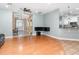 Open concept living area features hardwood floors, tray ceilings, and arched doorways at 433 Tangerine Ave, Lake Helen, FL 32744