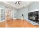 Bright living room with a fireplace, hardwood floors, and French doors leading to a study at 433 Tangerine Ave, Lake Helen, FL 32744