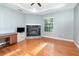 Spacious bedroom features a tray ceiling, a fireplace, and hardwood floors at 433 Tangerine Ave, Lake Helen, FL 32744
