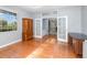 Bright office space featuring hardwood floors, large windows, and double glass doors at 433 Tangerine Ave, Lake Helen, FL 32744