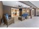 Covered patio with comfortable seating, ceiling fan, and view of the backyard at 433 Tangerine Ave, Lake Helen, FL 32744
