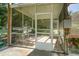 Enclosed screened porch area for outdoor living with utility sink and access door at 433 Tangerine Ave, Lake Helen, FL 32744