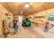 Organized shed interior with plywood walls, work benches, and lawn equipment at 433 Tangerine Ave, Lake Helen, FL 32744