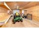 Spacious shed featuring a garage door, work benches, and lawn equipment at 433 Tangerine Ave, Lake Helen, FL 32744