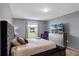 Comfortable bedroom with a plush bed, stylish dresser, and relaxing ambiance enhanced by natural light at 460 Flamingo Ct, Kissimmee, FL 34759