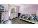 Charming bedroom with hardwood floors, a colorful theme, and ample natural light at 460 Flamingo Ct, Kissimmee, FL 34759
