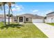 Charming single-story home with a well-maintained lawn, two-car garage, and inviting entryway at 460 Flamingo Ct, Kissimmee, FL 34759