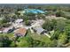 Expansive aerial view showcases the neighborhood, lush landscaping, and a school nearby at 4643 Fern Pine Dr, Orlando, FL 32808