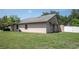 Well-maintained backyard features lush lawn and a private area with exterior entrance on the side of the home at 4643 Fern Pine Dr, Orlando, FL 32808