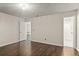 Bright bedroom with wood floors offers seamless access to the bathroom and other rooms at 4643 Fern Pine Dr, Orlando, FL 32808