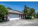 Charming single-story home featuring a two-car garage, manicured landscaping and a welcoming entrance at 4643 Fern Pine Dr, Orlando, FL 32808