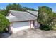 Charming single-story home featuring a two-car garage, manicured landscaping and a welcoming entrance at 4643 Fern Pine Dr, Orlando, FL 32808