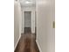 Hallway with wood flooring leading to several rooms in a home at 4643 Fern Pine Dr, Orlando, FL 32808