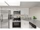 Updated kitchen featuring granite counters, stainless steel appliances and white cabinets at 4643 Fern Pine Dr, Orlando, FL 32808