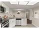 Bright kitchen with stainless steel appliances, granite counters, and white cabinetry at 4643 Fern Pine Dr, Orlando, FL 32808