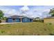 Spacious backyard featuring solar panels on the home's roof with a sunny, open lawn at 4843 Pierce Arrow Dr, Apopka, FL 32712