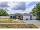 Charming single-story home with a well-maintained lawn and a bright yellow front door at 4843 Pierce Arrow Dr, Apopka, FL 32712