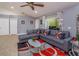Comfortable living room featuring stylish gray couches, modern rug, and bright window views at 4843 Pierce Arrow Dr, Apopka, FL 32712