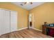 Bedroom featuring white closet doors, wood-look floors, and view to a hallway at 507 Westwind Dr, Davenport, FL 33896