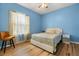 Inviting bedroom with hardwood floors, light blue walls, and lots of natural light at 507 Westwind Dr, Davenport, FL 33896