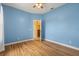 Bedroom featuring wood-look floors, blue walls and view to a hallway at 507 Westwind Dr, Davenport, FL 33896