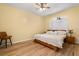 Comfortable bedroom featuring a ceiling fan, wood-look floors, and a window with natural light at 507 Westwind Dr, Davenport, FL 33896