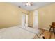 Bedroom with wood-look floors, ceiling fan, and view to the hallway at 507 Westwind Dr, Davenport, FL 33896