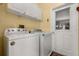 Convenient laundry room with washer, dryer, cabinets and exterior access at 507 Westwind Dr, Davenport, FL 33896